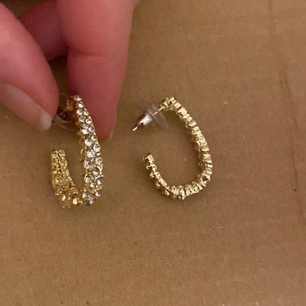 Gold half-hoop earrings with rhinestones